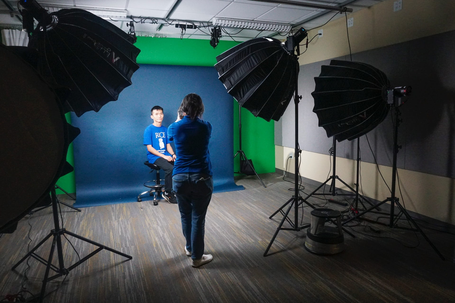 Student being photographed in a lighting studio